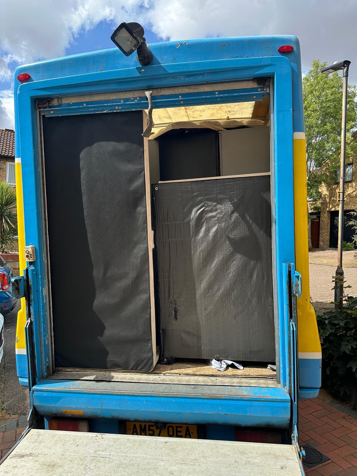 Van tail lift down with furniture wrapped and loaded ready for assembly delivery